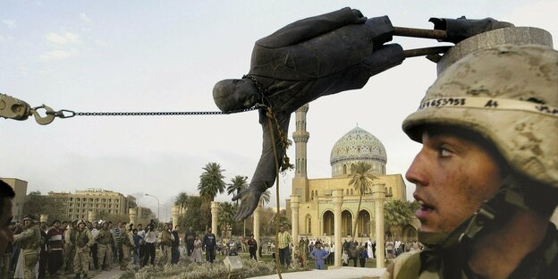 US military toppled a memorial to Saddam Hussein in Baghdad, 2003
