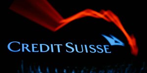 Ein roter, unscharfter Pfeil zeigt abwärts, über dem Namen der Bank: Credit Suisse