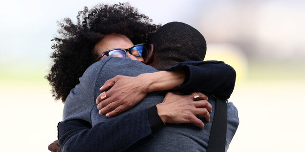 French journalist Olivier Dubois is hugged by a family member