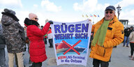 Demonstranten mit einem Schild, Aufschrift: Rügen wehrt sich. Kein LNG-Terminal in die Ostsee.