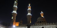 Minarette eine Kairiner Moschee vor dunklem Himmel.