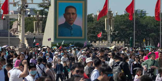 Eine große Menschenmenge versammelt sich während des Maifeiertags auf dem Platz des Himmlischen Friedens, wo ein Porträt von Sun Yat-sen hängt.