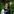 Ann-Kathrin Kelle hat lange braune Haare, trägt einen grauen Puli und steht in einem Garten