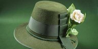 Grüner Filzhut mit Hutband an dem eine Rose befestigt ist