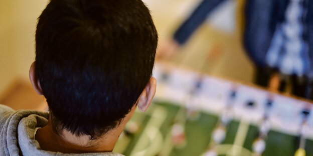 Der Hinterkopf eines Jungen vor einem Tischkicker im Kinder- und Jugendhilfezentrum der Heimstiftung Karlsruhe.