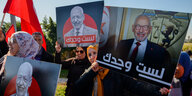 Frauen mit Kopftüchern halten Plakate des Oppositionspolitikers Ghannouchi