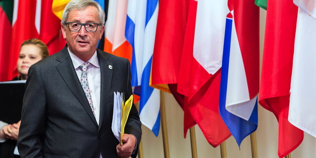 Jean-Claude Juncker vor verschiedenen Länderfahnen