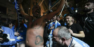 Die Maradonna Tätowierung auf dem Bauch eines Fußballfans mit nacktem Oberkörper wird im Jubel bestaunt