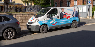 Ein Van mit weiß-blauer Farbe und AfD Logo