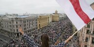 Protest in Minsk mit belarusisscher Flagge im Vordergrund