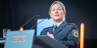 Claudia Pechstein in Uniform am Rednerpult