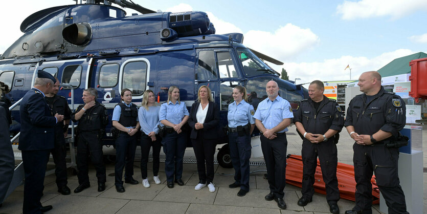 Nancy Faeser umringt von Bundespolizisten vor einem Helicopter