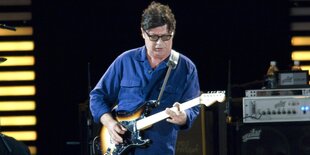 Robbie Robertson mit Gitarre auf der Bühne.