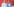 Olaf Scholz und Nancy Faeser stehen nebeneinander vor einem roten Hintergrund
