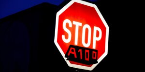 Ein Stopschild mit dem dazugeklebten Zusatz "A100"