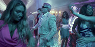 Ein älterer Mann tanzt in einem Club unter jungen Frauen