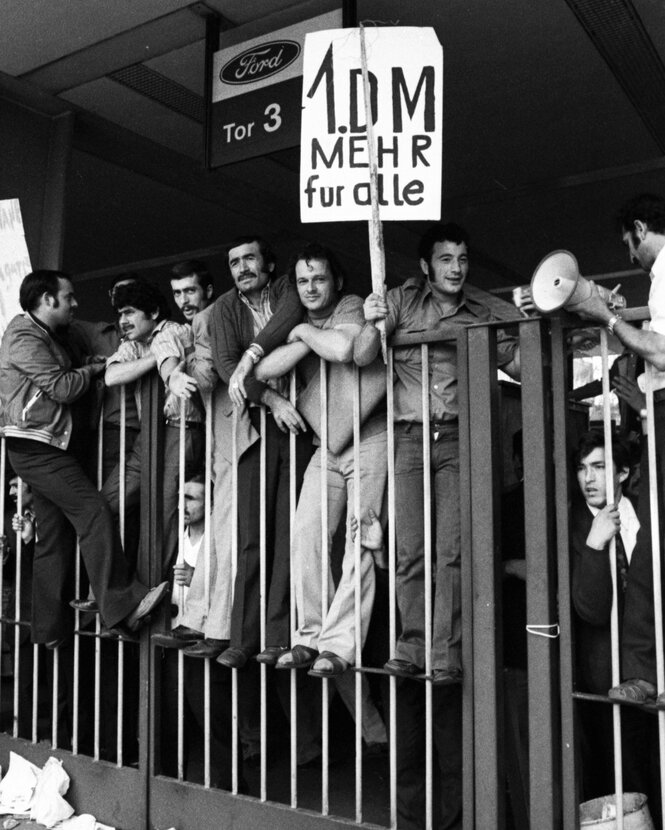 Historischen Aufnahme Streikender an einem Fabriktor.