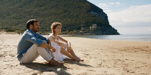 Edoardo Leo und Ksenia Rappoport sitzen am Strand. Szene aus "L'Ordine del Tempo"