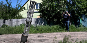 Eine Rackete mit gestellartigen Stangen steckt im Boden vor einem Wohnhaus bei Charkiv am 10. Juni 2022