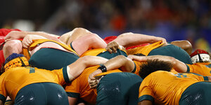 Australische Rugby-Nationalteam, aneinandergedrängt, in gebückter Haltung, von hinten fotografiert