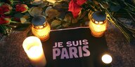 Blumen und Kerzen auf dem Gehweg zum Gedenken an die Opfer der Terroranschläge in Paris am 15. November 2015