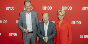 Mathias Döpfner, Olaf Scholz und Marion Horn vor einer roten Bild-Logo-Wand