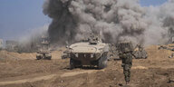 Panzer, israelische Soldaten und eine große Staubwolke nach einer Explosion