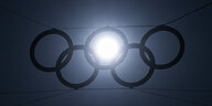 Die tiefstehende Sonne scheint durch einen der fünf Ringe über dem Eingang zum Olympiastadion.
