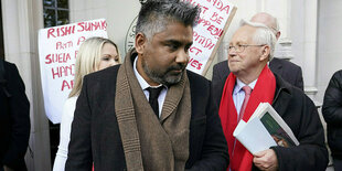 Der Rechtsanwalt Toufique Hossain mit braunem Schal steht mit anderen vor dem Supreme Court in London