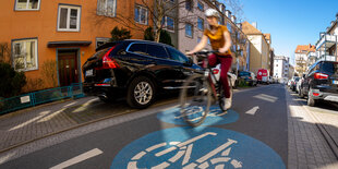 Eine Frau fährt in einer Fahrradstraße Rad