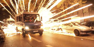 Feuerwerkskörper fliegen hinter einem Polizeiauto in Neukölln.