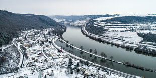 Kleine Dörfer in einem Tal im Schnee, Flußlauf