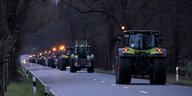 Traktoren auf der Landstraße im Dunkeln