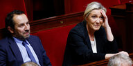 Ein Mann und eine Frau im Rahmen der Nationalversammlung in Paris.