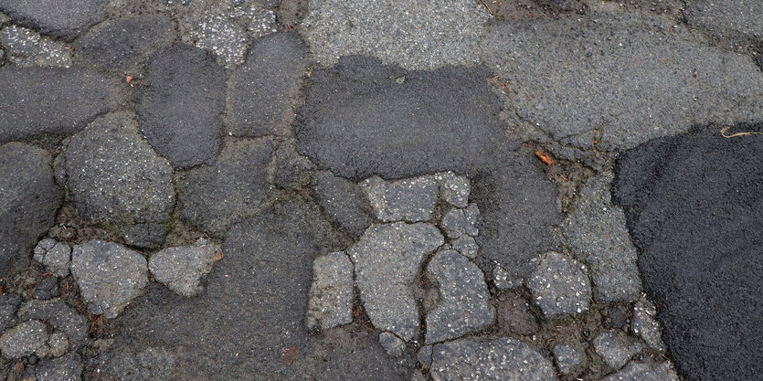 Mehrfach geflickte Straßenoberfläche