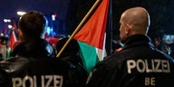 Zwei Polizisten beabachten eine Pro-Palästina-Demonstration.