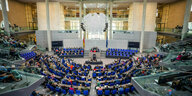 Im Plenarsaal des Bundestags sitzen die Abgeordneten
