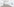 Karen Kilimniks Strand-Gemälde hängen bei Sprüth Magers auf drei weiße Wände verteilt. In der Raummitte stehen zwei türkisfarbene Sockel, auf denen links ein Wasserglas und rechts eine Skulptur aus Rahmenstück liegen. Es ist mit transparent schillernden Steinen in verschiedenen Farben beklebt.