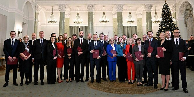 Die Mitglieder der neuen polnischen Regierung stehen nebeneinander für's 