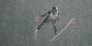 Andreas Wellinger fliegt in diochtem Schneegestäber durch die Luft