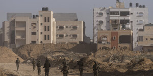 Israelische Soldaten gehen während einer Bodenoperation durch ein starl beschädigtes Wohnviertel