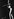 Schwarz-Weiß-Fotografie der Tänzerin und Sängerin Josephine Baker steht auf einer Bühne mit einem Mikrofon in der Hand. Sie trägt einen Overall, der mit Strasssteinen besetzt ist. Ihr Haardutt ist ebenfalls mit Strasssteinen bestückt. Sie hebt den Arm in