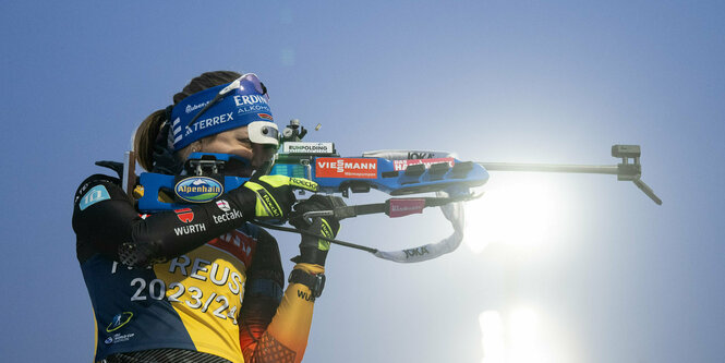 Biathlonschützin schießt bei einem Rennen.