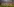 Spieler von FC Bayern in rot-weißen Trikots stehen am Rand des Spielfeldes, im Hintergrund die hohe Zuschauertribüne