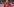 Jan Urbas während einem Spiel. Er trägt ein rotes Trikot und einen Orangenen Helm. Seine linke Hand, in Handschuh, hat er erhoben. Im Hintergrund Publikum und ien weiterer Spieler auf demEis.
