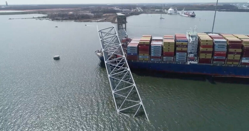 Ein Foto aus der Vogelperspektive zeigt das Containerschiff und die eingestürzte Brücke auf dem Patapsco River in Baltimore bei Tage.