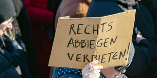 Während einer Demonstration gegen Rechts hält eine Person ein Protest-Schild in die Höhe.