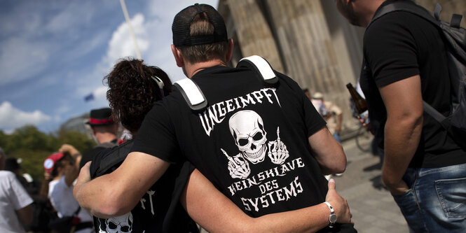 Demonstrant mit T-Shirt Ungeimpft Kein Sklave des Systems und Totenkopf auf der Kundgebung und Demonstration von sogenannten "Corona-Leugnern"