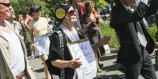 Eine Demonstrantin hält ein Schild mit der Aufschrift "Cum Ex, Cum Cum - aus der Traum"