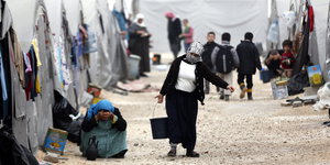 Flüchtlinge vor ihren Zelten in einem Flüchtlingscamp